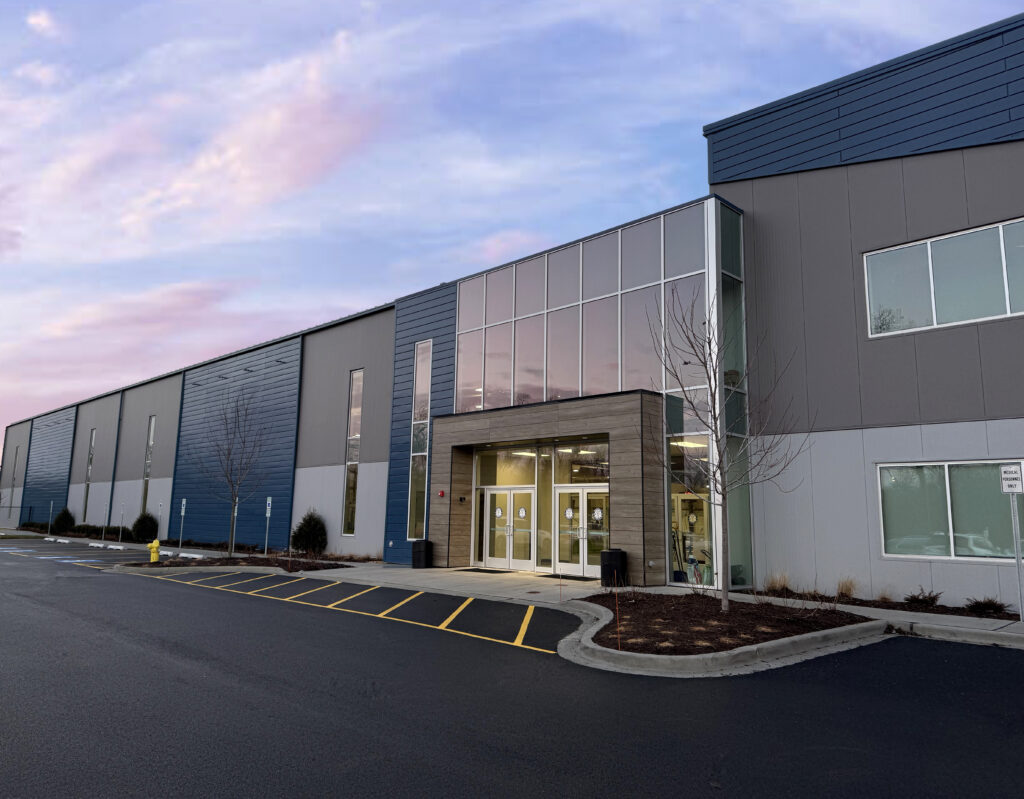 The exterior of Sawmill Sports Hub with a beautiful blue, purple and pink sky.