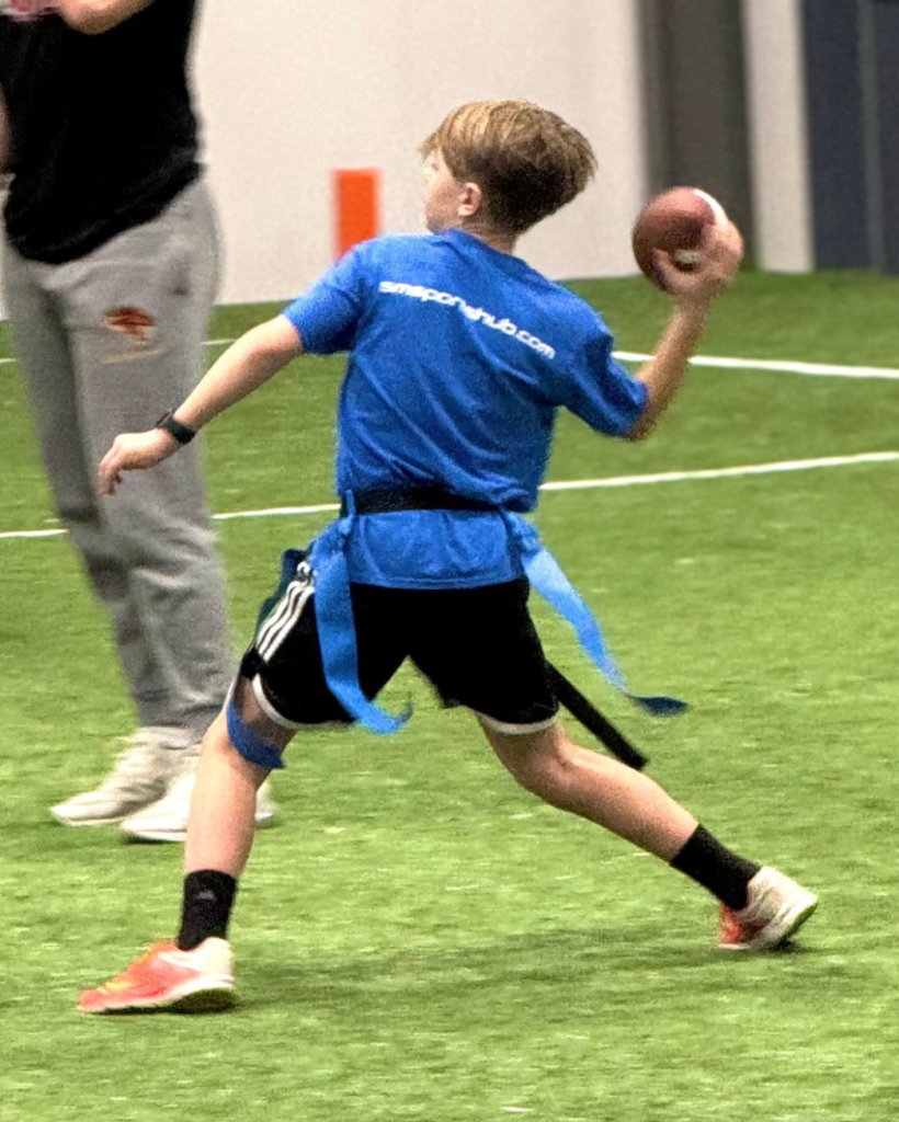 A young flag football player throws a ball.