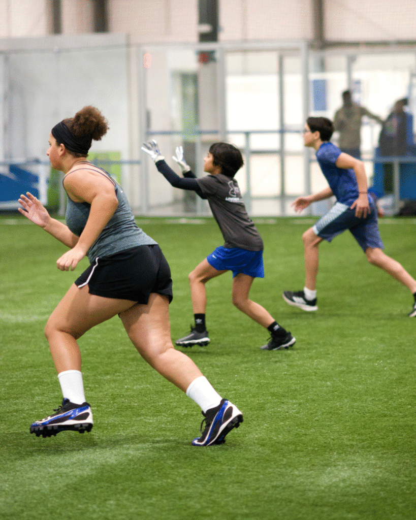 Kids running and doing football drills at Sawmill Sports Hub's Football Camp