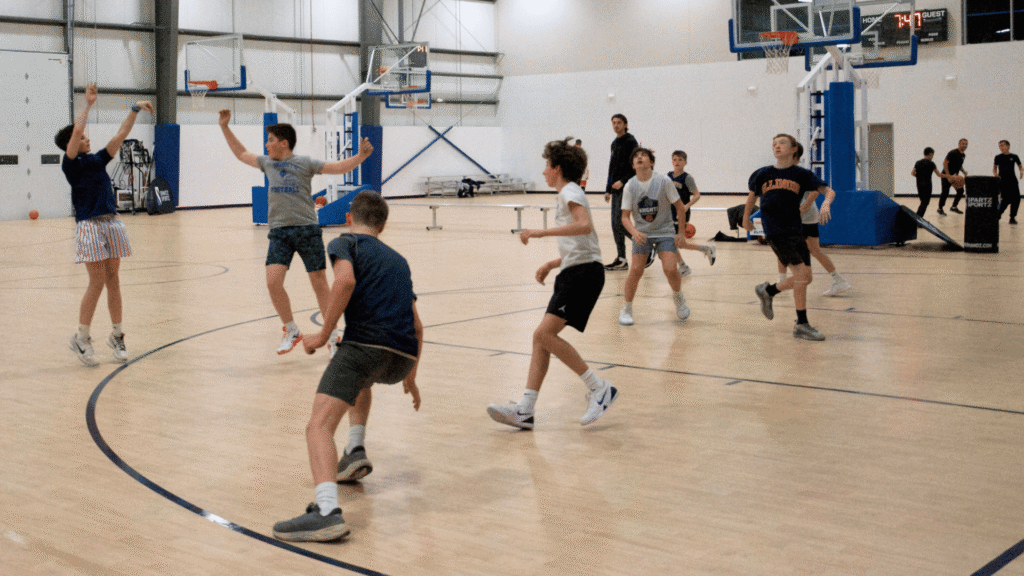 Kids playing basketball on the court at Sawmill Sports Hub.