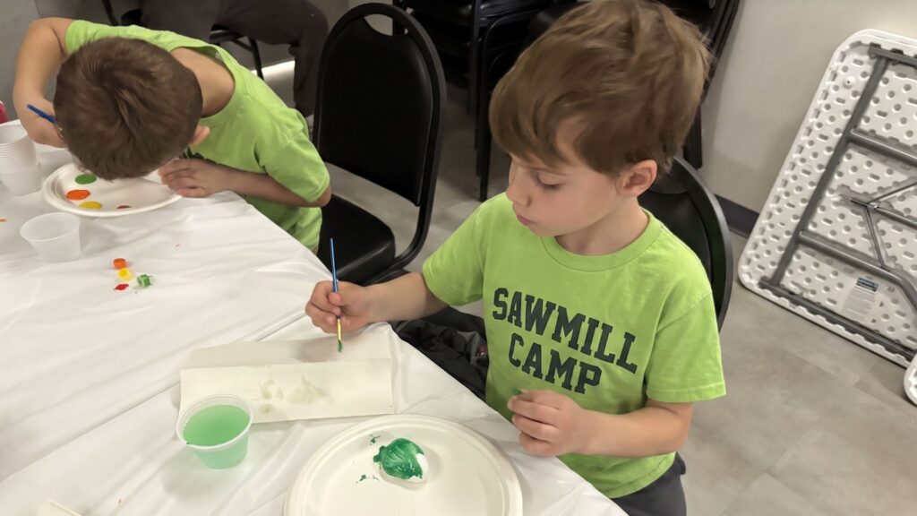 Kids do crafts indoors at Sawmill Sports Hub summer camp.