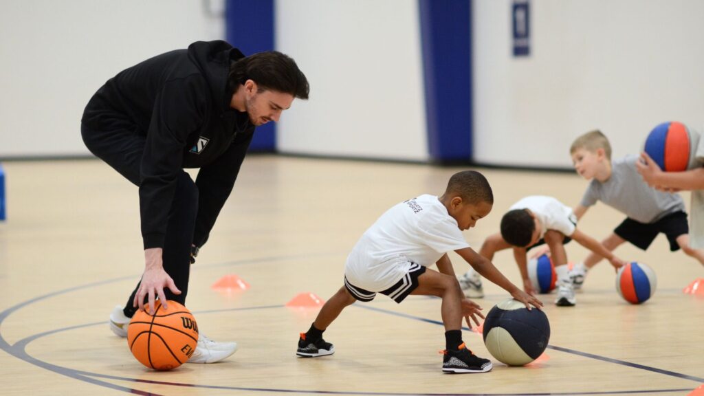 Kids ages 3-5 practice ball skills during a Lil' Hoopers class at Sawmill Sports Hub