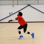 A girl bumping a volleyball at Sawmill Sports Hub.