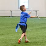 A boy catches a football at Sawmill's football summer camp.