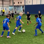 Kids playing a soccer game inside Sawmill Sports Hub